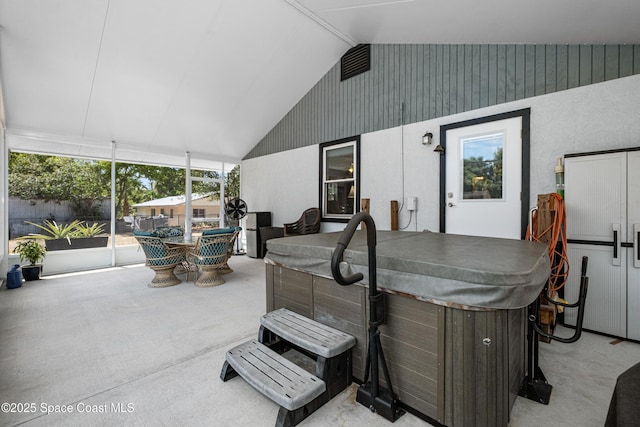 view of patio featuring a hot tub, fence, and outdoor dining area