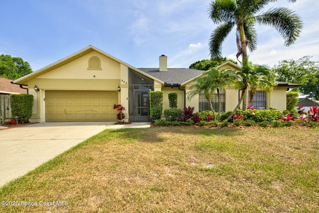 view of front of house featuring a front lawn, driveway, a chimney, a garage, and stucco siding