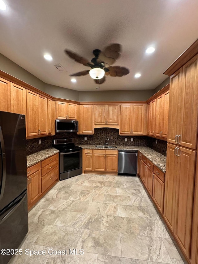 kitchen featuring stainless steel appliances, visible vents, a sink, and backsplash