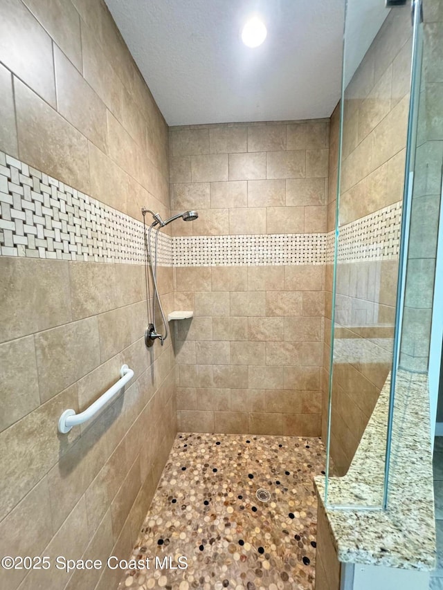 bathroom with tiled shower