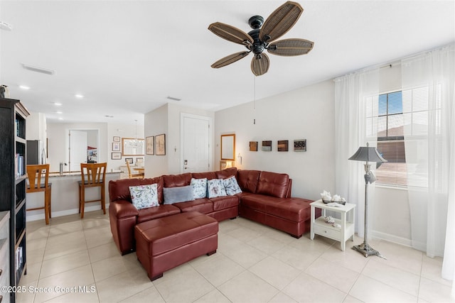 living room featuring light tile patterned floors, ceiling fan, visible vents, baseboards, and recessed lighting