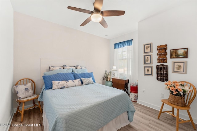 bedroom with wood finished floors, ceiling fan, and baseboards