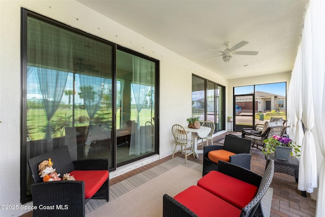 sunroom featuring a ceiling fan