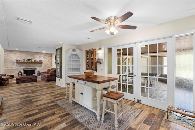 800 Hidden Oaks Ln, Oak Hill, FL 32759 - dining space featuring french doors, a textured ceiling, visible vents, a ceiling fan, and dark wood-type flooring