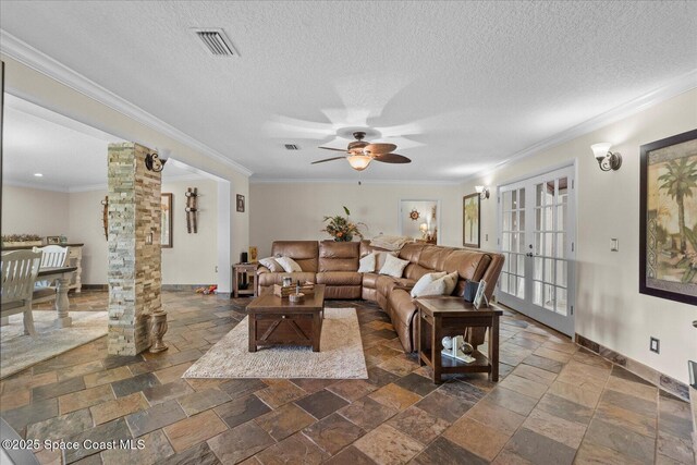 800 Hidden Oaks Ln, Oak Hill, FL 32759 - living area featuring stone tile flooring, ceiling fan, visible vents, and ornate columns