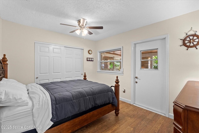 800 Hidden Oaks Ln, Oak Hill, FL 32759 - bedroom featuring a ceiling fan, wood finished floors, a textured ceiling, and a closet