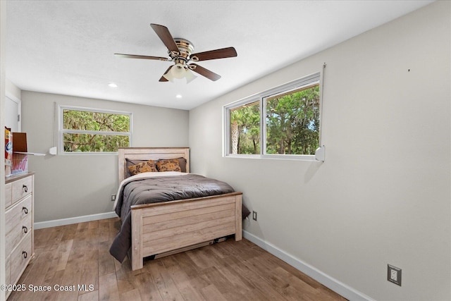 800 Hidden Oaks Ln, Oak Hill, FL 32759 - bedroom featuring ceiling fan, baseboards, light wood finished floors, and recessed lighting