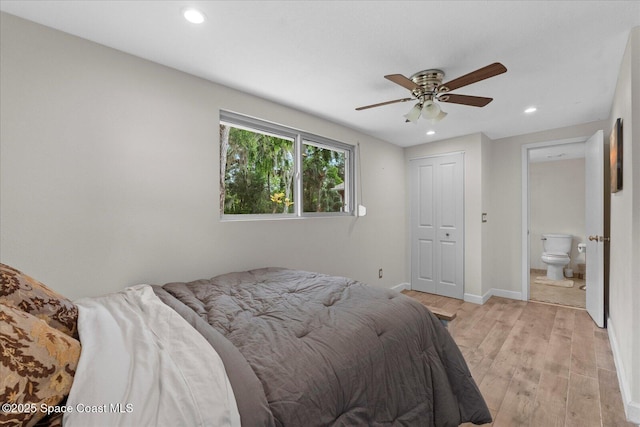800 Hidden Oaks Ln, Oak Hill, FL 32759 - bedroom with a ceiling fan, connected bathroom, light wood-type flooring, baseboards, and recessed lighting
