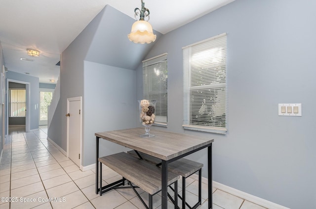 dining room with light tile patterned flooring and baseboards