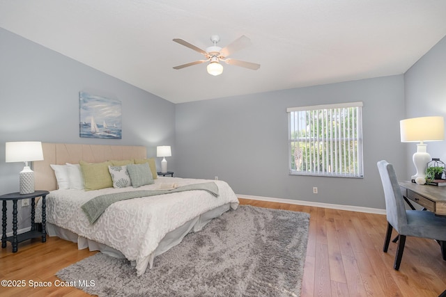 bedroom with wood finished floors, baseboards, and a ceiling fan