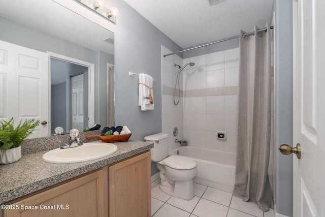 bathroom with tile patterned flooring, vanity, toilet, and shower / tub combination