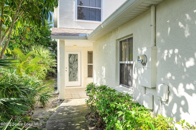 entrance to property featuring stucco siding