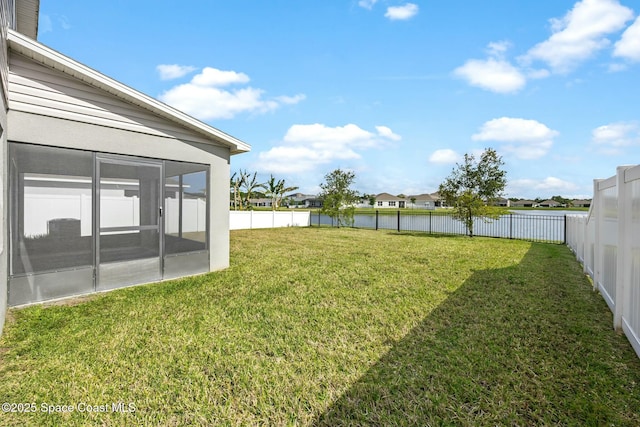 view of yard with a fenced backyard, a sunroom, and a residential view
