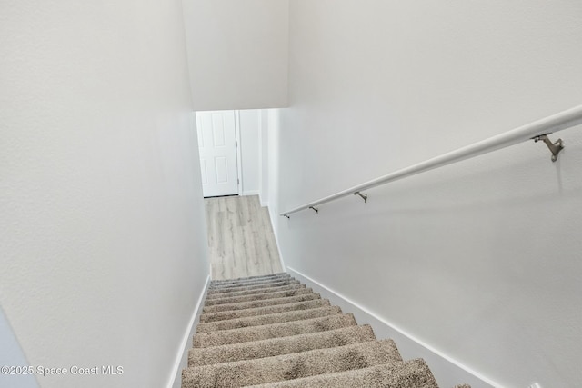 stairway featuring baseboards