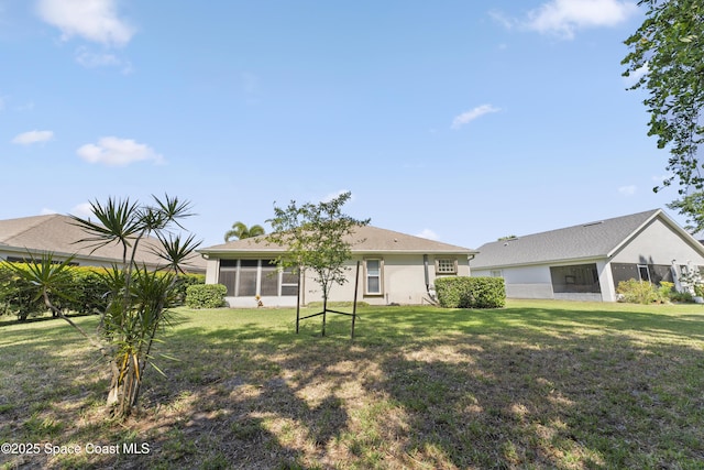 1773 Sun Gazer Dr, Rockledge, FL 32955 - rear view of house featuring a lawn and a sunroom