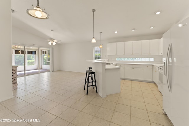 1773 Sun Gazer Dr, Rockledge, FL 32955 - kitchen with a wealth of natural light, open floor plan, vaulted ceiling, and white appliances