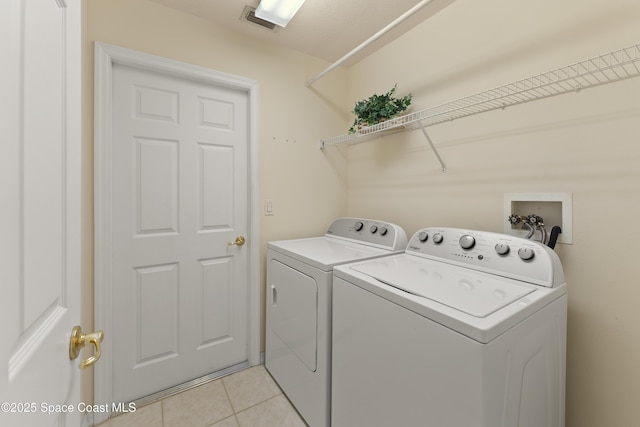 1773 Sun Gazer Dr, Rockledge, FL 32955 - washroom with visible vents, washer and dryer, laundry area, and light tile patterned floors