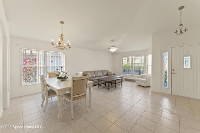 1773 Sun Gazer Dr, Rockledge, FL 32955 - dining area featuring ceiling fan with notable chandelier, baseboards, and light tile patterned flooring