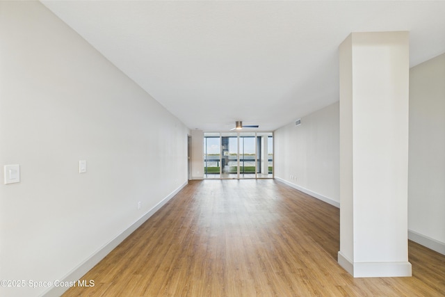 300 S Sykes Creek Pkwy Unit 106, Merritt Island, FL 32952 - spare room featuring light wood-type flooring, baseboards, visible vents, and expansive windows