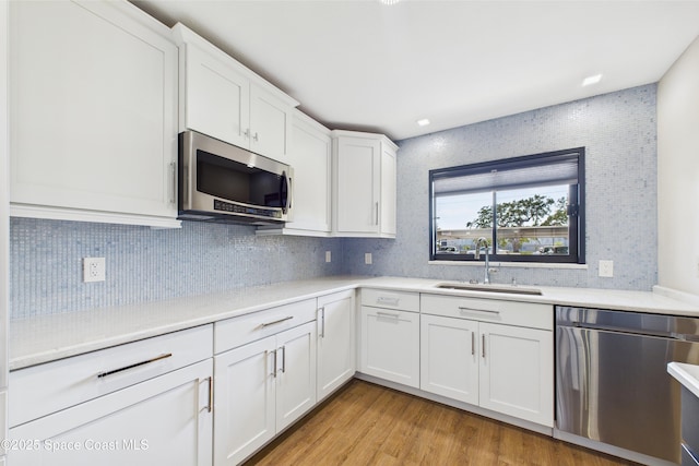 300 S Sykes Creek Pkwy Unit 106, Merritt Island, FL 32952 - kitchen featuring a sink, appliances with stainless steel finishes, white cabinets, and light countertops