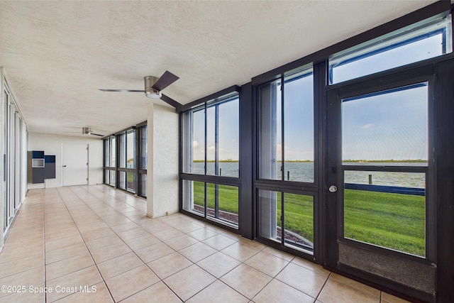 300 S Sykes Creek Pkwy Unit 106, Merritt Island, FL 32952 - unfurnished sunroom with a water view, french doors, tile patterned floors, and a textured ceiling