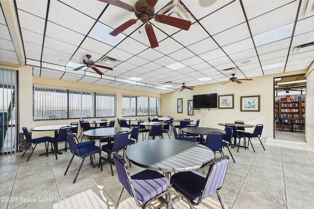 300 S Sykes Creek Pkwy Unit 106, Merritt Island, FL 32952 - dining space with ceiling fan, visible vents, and a drop ceiling