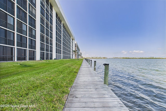 300 S Sykes Creek Pkwy Unit 106, Merritt Island, FL 32952 - view of dock with a water view and a yard