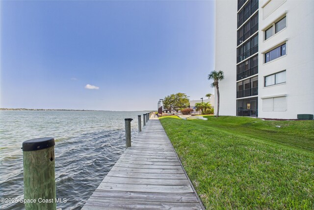300 S Sykes Creek Pkwy Unit 106, Merritt Island, FL 32952 - dock area featuring a lawn and a water view