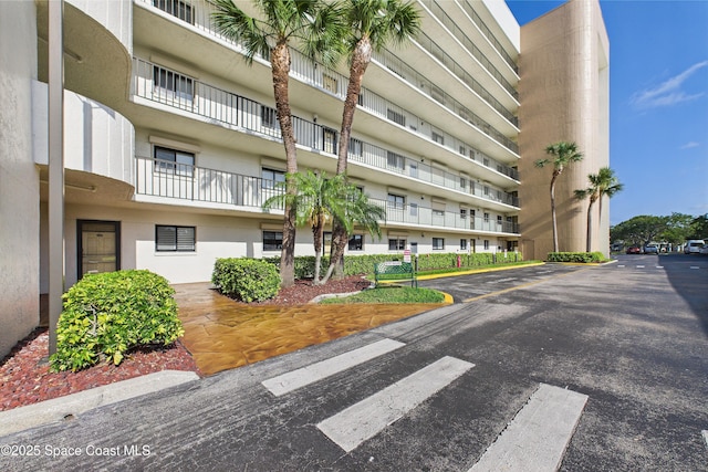 300 S Sykes Creek Pkwy Unit 106, Merritt Island, FL 32952 - view of apartment building / complex with uncovered parking