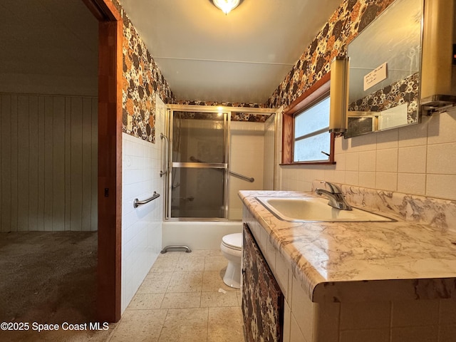 690 Lemon Grove Ave, Melbourne, FL 32904 - bathroom with vanity, shower / bath combination with glass door, and wainscoting