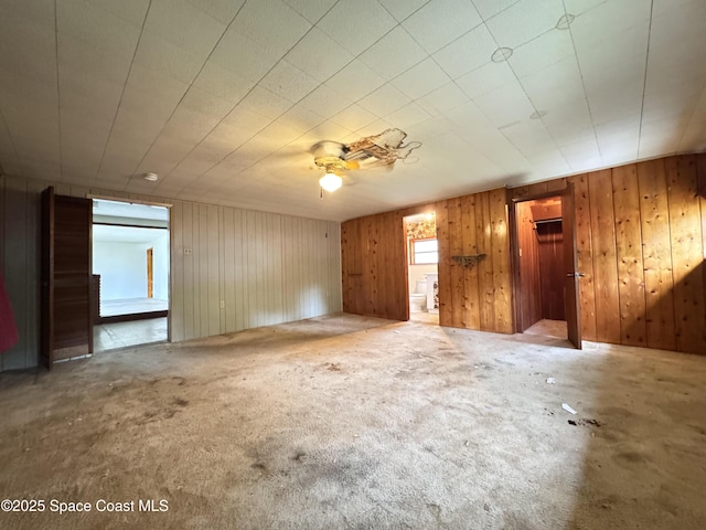 690 Lemon Grove Ave, Melbourne, FL 32904 - unfurnished room with carpet, wood walls, and ceiling fan
