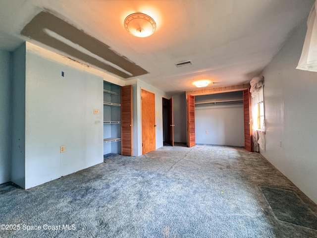 690 Lemon Grove Ave, Melbourne, FL 32904 - unfurnished bedroom with two closets and carpet flooring