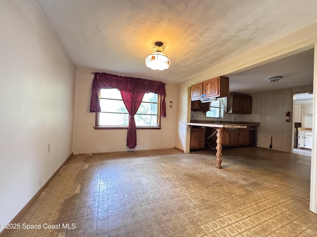 690 Lemon Grove Ave, Melbourne, FL 32904 - kitchen with light countertops, light flooring, and brown cabinetry