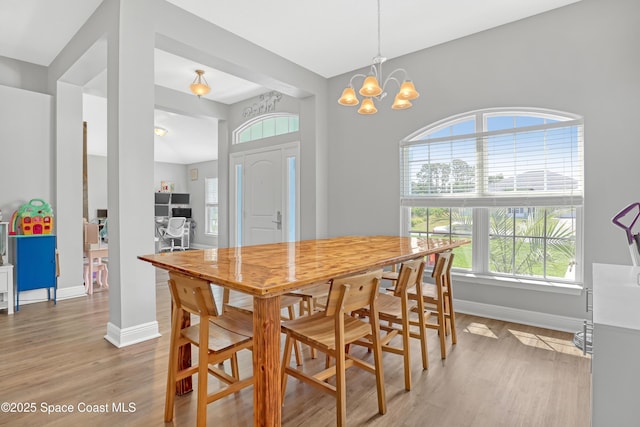 1307 Lotus St SE, Palm Bay, FL 32909 - dining room featuring baseboards, light wood-style flooring, a chandelier, and an office area