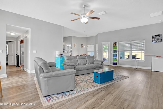 1307 Lotus St SE, Palm Bay, FL 32909 - living room featuring ceiling fan, wood finished floors, and baseboards