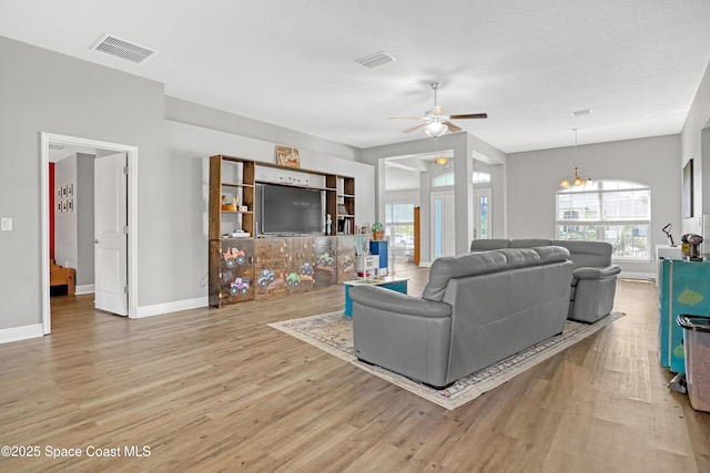 1307 Lotus St SE, Palm Bay, FL 32909 - living room with light wood-style floors, ceiling fan, plenty of natural light, and baseboards