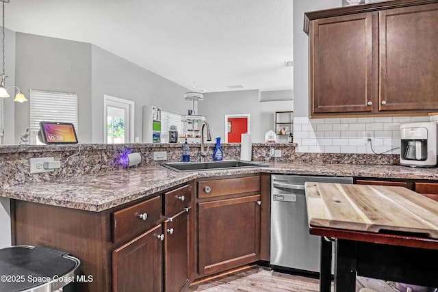 1307 Lotus St SE, Palm Bay, FL 32909 - kitchen featuring a sink, stainless steel dishwasher, light wood-style floors, tasteful backsplash, and dark brown cabinets
