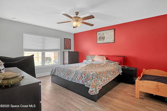 1307 Lotus St SE, Palm Bay, FL 32909 - bedroom featuring wood finished floors, a ceiling fan, and baseboards