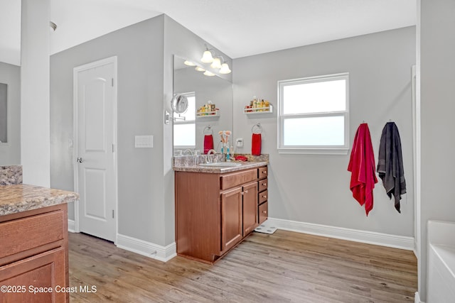 1307 Lotus St SE, Palm Bay, FL 32909 - bathroom featuring wood finished floors, vanity, and baseboards