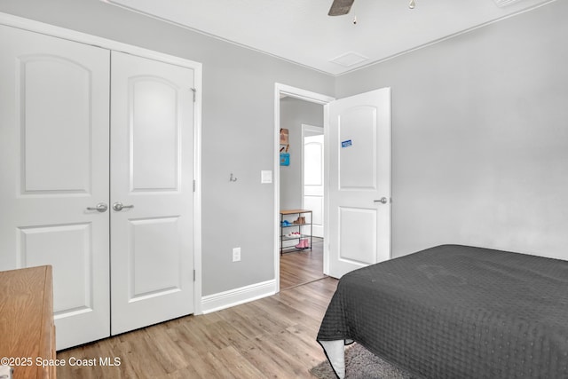 1307 Lotus St SE, Palm Bay, FL 32909 - bedroom featuring light wood-style floors, baseboards, ceiling fan, and a closet