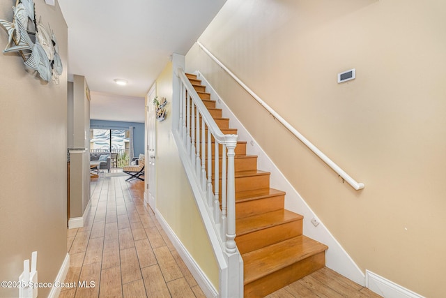 5350 Ocean Beach Blvd Unit 212, Cocoa Beach, FL 32931 - staircase featuring wood finished floors and baseboards