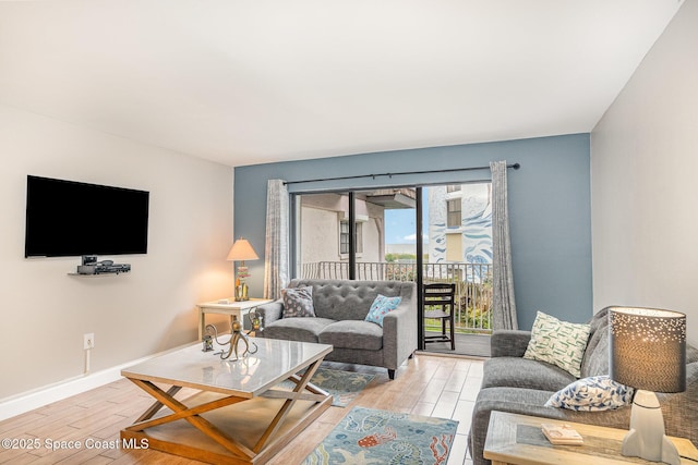5350 Ocean Beach Blvd Unit 212, Cocoa Beach, FL 32931 - living room featuring light wood-style flooring and baseboards