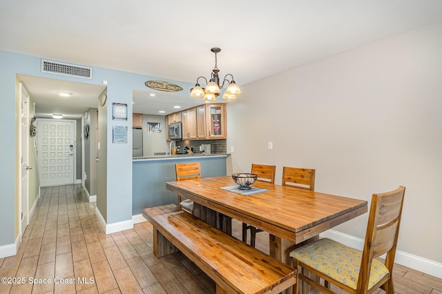 5350 Ocean Beach Blvd Unit 212, Cocoa Beach, FL 32931 - dining space with recessed lighting, light wood finished floors, visible vents, baseboards, and a chandelier