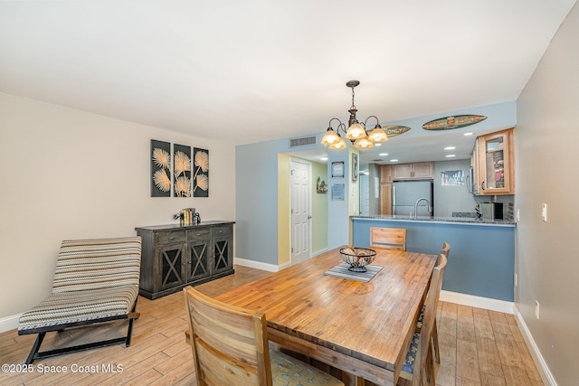 5350 Ocean Beach Blvd Unit 212, Cocoa Beach, FL 32931 - dining room with light wood-type flooring, baseboards, and visible vents