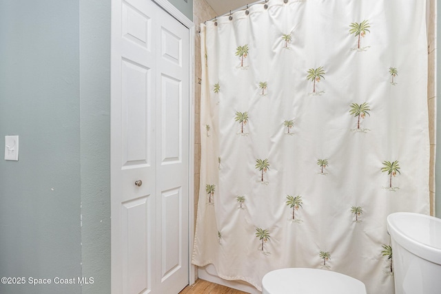5350 Ocean Beach Blvd Unit 212, Cocoa Beach, FL 32931 - full bath featuring a shower with curtain, wood finished floors, and toilet