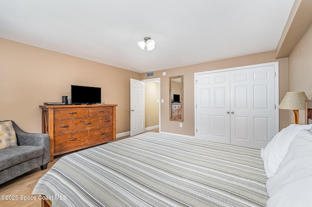 5350 Ocean Beach Blvd Unit 212, Cocoa Beach, FL 32931 - bedroom featuring a closet, baseboards, light wood-style floors, and visible vents