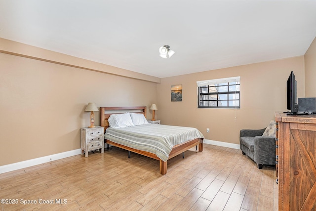 5350 Ocean Beach Blvd Unit 212, Cocoa Beach, FL 32931 - bedroom featuring light wood-style flooring and baseboards