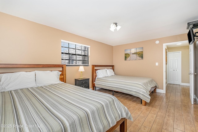 5350 Ocean Beach Blvd Unit 212, Cocoa Beach, FL 32931 - bedroom featuring light wood-style floors and baseboards