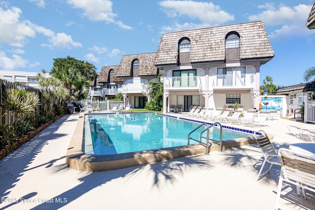 5350 Ocean Beach Blvd Unit 212, Cocoa Beach, FL 32931 - pool with a patio area and fence
