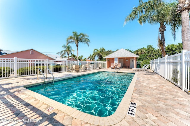 pool featuring a patio area and fence